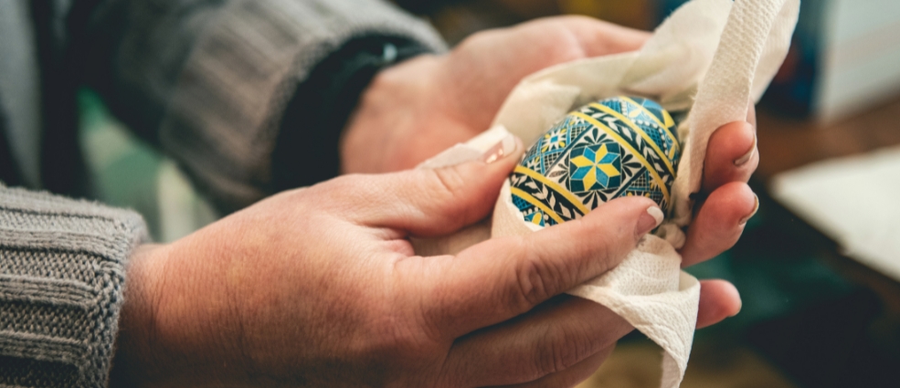 Person wiping a Ukrainian traditional pysanky egg